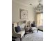 Cozy seating area with elegant chairs, decorative pillows, and a stylish chandelier at 2408 Merion Creek Dr, Apex, NC 27539