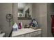 Tiled bathroom with a gray countertop sink and mirrored medicine cabinet at 257 E Raleigh Blvd, Rocky Mount, NC 27801