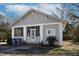 Charming bungalow-style home with gray siding, brick accents, and a screened-in front porch at 257 E Raleigh Blvd, Rocky Mount, NC 27801