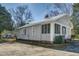 Side view of a cozy home featuring a screened porch and durable gray siding, perfect for easy maintenance at 257 E Raleigh Blvd, Rocky Mount, NC 27801