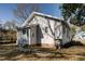 Charming bungalow featuring a blue door, gray siding, and well-maintained landscaping on a sunny day at 257 E Raleigh Blvd, Rocky Mount, NC 27801