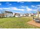 Expansive backyard with a mix of a full green lawn and a deck with a table and chairs at 2604 Smoky Topaz Ln, Raleigh, NC 27610