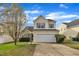 Charming two-story home boasts a manicured lawn and attached two-car garage at 2604 Smoky Topaz Ln, Raleigh, NC 27610