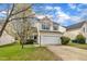 Charming two-story home boasts a manicured lawn and attached two-car garage at 2604 Smoky Topaz Ln, Raleigh, NC 27610