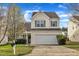 Charming two-story home boasts a manicured lawn and attached two-car garage at 2604 Smoky Topaz Ln, Raleigh, NC 27610
