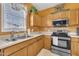 Cozy kitchen showcasing stainless appliances and light-wood cabinets at 2604 Smoky Topaz Ln, Raleigh, NC 27610