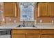 This kitchen includes stainless steel sink with window and light-wood cabinets at 2604 Smoky Topaz Ln, Raleigh, NC 27610