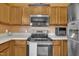 Kitchen featuring stainless appliances and light-wood cabinetry at 2604 Smoky Topaz Ln, Raleigh, NC 27610