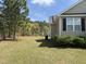 Expansive backyard with lush green grass and mature trees, offering privacy and plenty of space for outdoor activities at 27 Belmont Ct, Lillington, NC 27546