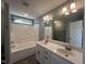 Bathroom featuring double sinks, modern fixtures, and a shower-tub combo at 27 Belmont Ct, Lillington, NC 27546