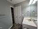 Bathroom featuring a sink, mirror, and storage shelves at 27 Belmont Ct, Lillington, NC 27546