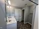 Bright bathroom with double vanity, large mirror, and storage at 27 Belmont Ct, Lillington, NC 27546