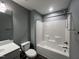 Bathroom featuring a shower-tub combo, toilet, and vanity sink at 27 Belmont Ct, Lillington, NC 27546