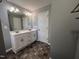 Bathroom featuring double sinks with white cabinets and modern hardware at 27 Belmont Ct, Lillington, NC 27546