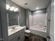 Clean bathroom featuring a shower-tub combo and vanity sink at 27 Belmont Ct, Lillington, NC 27546
