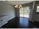 Dining area with hardwood floors, contemporary chandelier, and sliding doors to outdoor deck at 27 Belmont Ct, Lillington, NC 27546