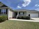 Charming single-story home showcasing a manicured lawn and a welcoming covered front porch at 27 Belmont Ct, Lillington, NC 27546