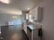 Bright kitchen with granite countertops, white cabinets and view to the adjacent dining area at 27 Belmont Ct, Lillington, NC 27546