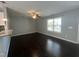 Cozy living room with hardwood floors, ceiling fan, and a large window bringing in natural light at 27 Belmont Ct, Lillington, NC 27546