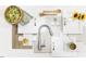 Kitchen layout featuring a stainless steel faucet, wood spoons, flowers, and a fresh bowl of salad at 817 Central Pk Dr, Raleigh, NC 27604