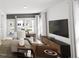 Inviting living room featuring a comfortable seating area, large windows, and a sleek entertainment center at 817 Central Pk Dr, Raleigh, NC 27604