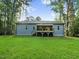View of a backyard with a deck and manicured lawn, and exterior home at 303 Cherrybirch Ln, Zebulon, NC 27597