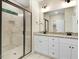 Elegant bathroom with granite countertops, double sinks, and a glass-enclosed shower, providing a spa-like experience at 303 Cherrybirch Ln, Zebulon, NC 27597