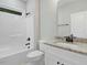 Bathroom boasts a shower/tub combo and a vanity with a granite countertop at 303 Cherrybirch Ln, Zebulon, NC 27597