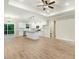 Open-concept living space with modern lighting, hardwood floors, and a stylish kitchen with an island at 303 Cherrybirch Ln, Zebulon, NC 27597