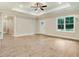 Open-concept living space with natural lighting, hardwood floors, and a view of the backyard at 303 Cherrybirch Ln, Zebulon, NC 27597