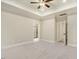 Large main bedroom featuring tray ceilings, neutral walls, and doorways to the bathroom and closet at 303 Cherrybirch Ln, Zebulon, NC 27597