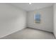 Cozy bedroom with soft carpet, neutral walls, and a window overlooking the front yard at 308 Arch Canyon Cir, Zebulon, NC 27597