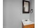 Bathroom features a wooden vanity and a decorative mirror at 312 E Highland Ave, Rocky Mount, NC 27801