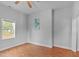 A bedroom features laminate floors, ceiling fan, and natural light from the window at 312 E Highland Ave, Rocky Mount, NC 27801