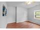 Bedroom featuring wood flooring, a ceiling fan, a door, and a window at 312 E Highland Ave, Rocky Mount, NC 27801