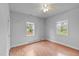 Bedroom featuring wood flooring, two windows with natural light, and neutral walls at 312 E Highland Ave, Rocky Mount, NC 27801