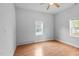 A bright bedroom features laminate floors, ceiling fan, and natural light from the windows at 312 E Highland Ave, Rocky Mount, NC 27801