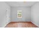 Bedroom featuring wood flooring, a window with natural light, and a door at 312 E Highland Ave, Rocky Mount, NC 27801