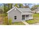 Newly renovated single-story home with a cozy front porch, updated siding, and a well-manicured lawn at 312 E Highland Ave, Rocky Mount, NC 27801