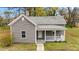 Charming one-story home with freshly painted siding, a welcoming front porch, and a beautifully maintained front yard at 312 E Highland Ave, Rocky Mount, NC 27801