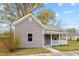 Charming single-story home with gray siding, covered porch, and well-maintained front yard at 312 E Highland Ave, Rocky Mount, NC 27801