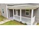 A view of the house's front porch and door, featuring updated siding and a well-manicured lawn at 312 E Highland Ave, Rocky Mount, NC 27801