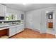 Kitchen featuring wood floors, white cabinets, granite countertops, and a view at 312 E Highland Ave, Rocky Mount, NC 27801