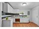 Kitchen featuring granite countertops, white cabinets, and backsplash at 312 E Highland Ave, Rocky Mount, NC 27801