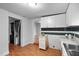 Kitchen with stainless sink, white cabinets, and black and white backsplash at 312 E Highland Ave, Rocky Mount, NC 27801