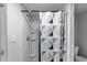 Bathroom shower area featuring a modern shower head and patterned curtain at 312 E Highland Ave, Rocky Mount, NC 27801