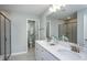 Modern bathroom featuring double sinks, quartz countertops, and a glass-enclosed shower at 355 Fosterton Cottage Way, Raleigh, NC 27603