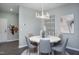 Stylish dining room with a modern light fixture, seating for six, and contemporary decor at 355 Fosterton Cottage Way, Raleigh, NC 27603