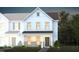 Charming two-story home with white siding, a cozy front porch, and manicured landscaping at 355 Fosterton Cottage Way, Raleigh, NC 27603