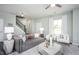 Comfortable living area featuring stylish decor, neutral colors, and plenty of natural light with view to the staircase at 355 Fosterton Cottage Way, Raleigh, NC 27603